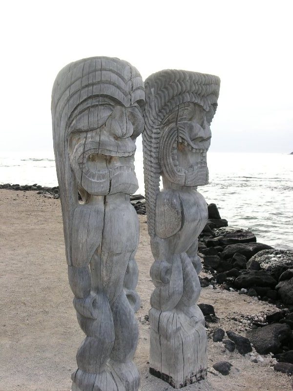photo of two idol statues at place of refuge, big island, hawaii